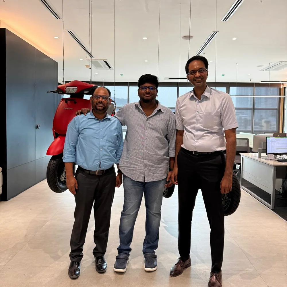Madhiee meeting business leaders inside an electric vehicle workspace